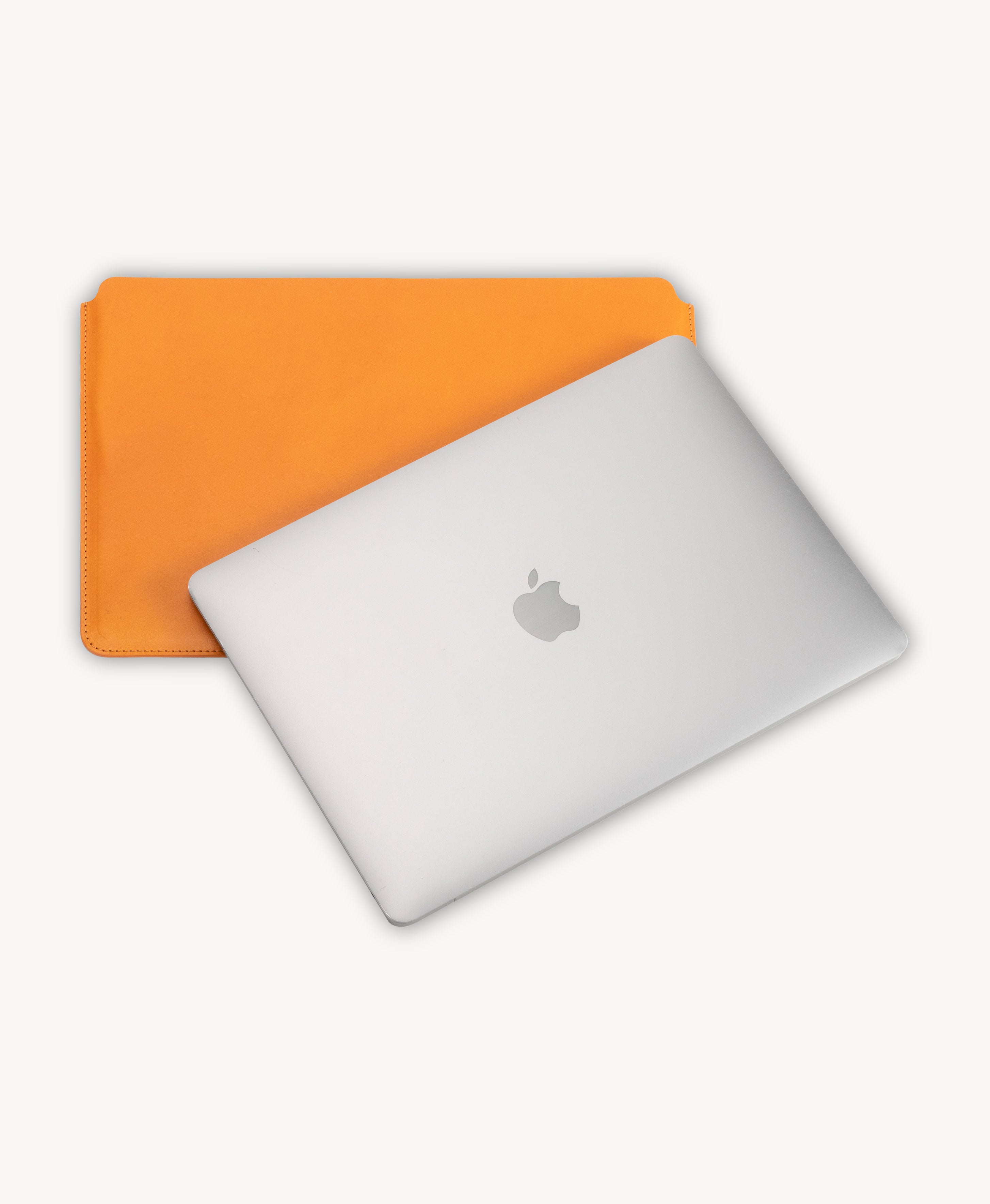 Honey Tan full grain saddle leather laptop sleeve, shown with a MacBook