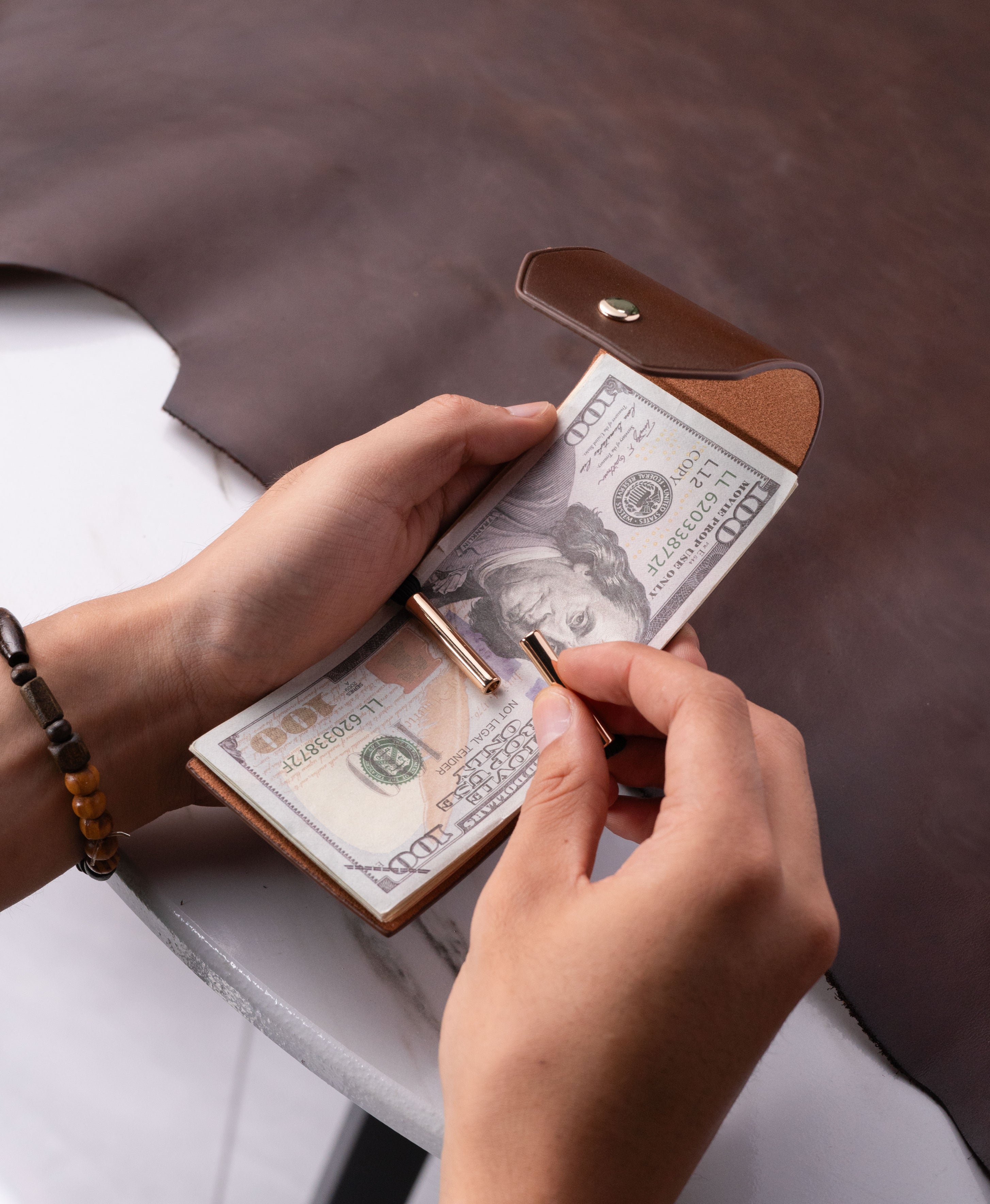 Brown full-grain saddle leather cash wrap wallet lifestyle view 1