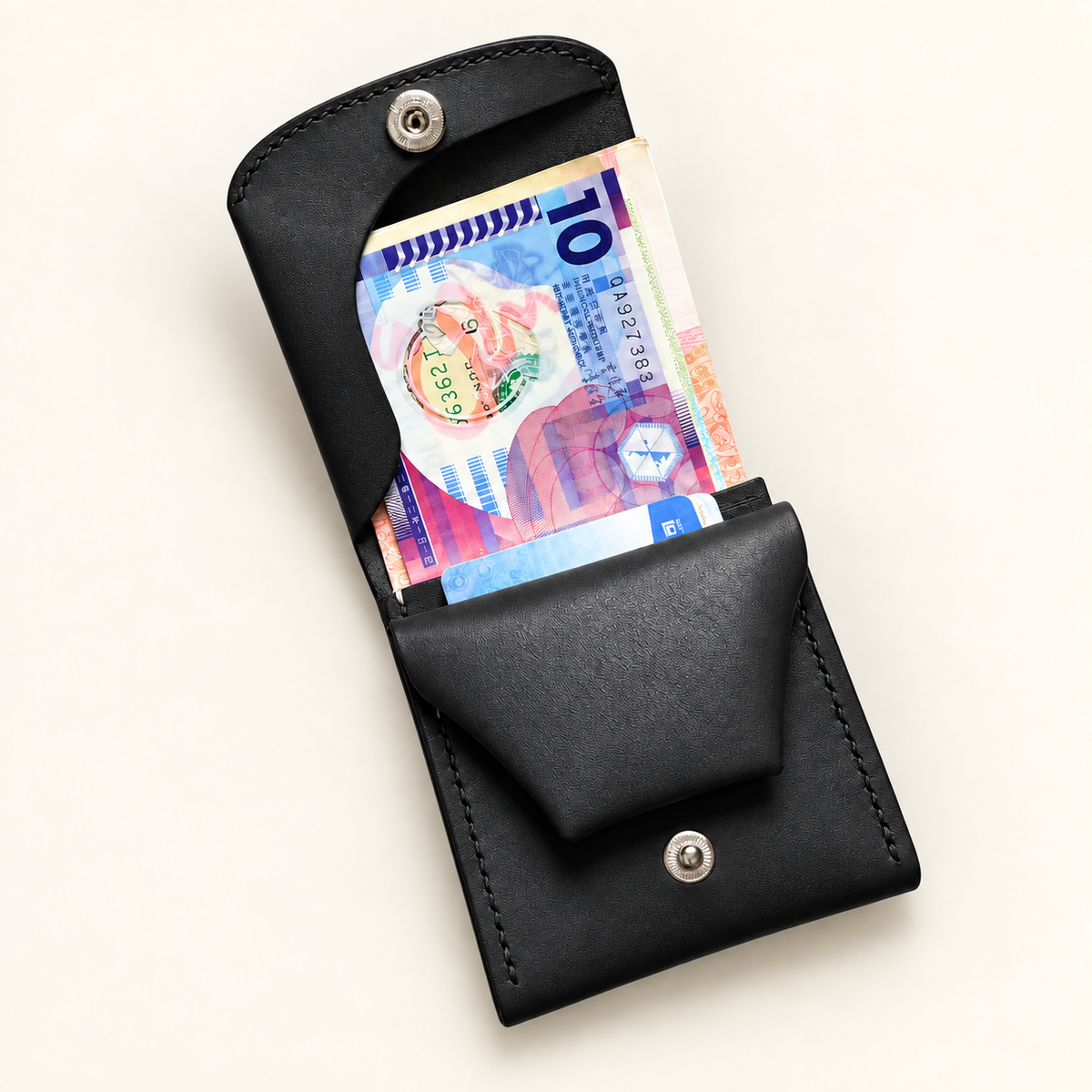 Black leather wallet opened to show banknotes and card storage