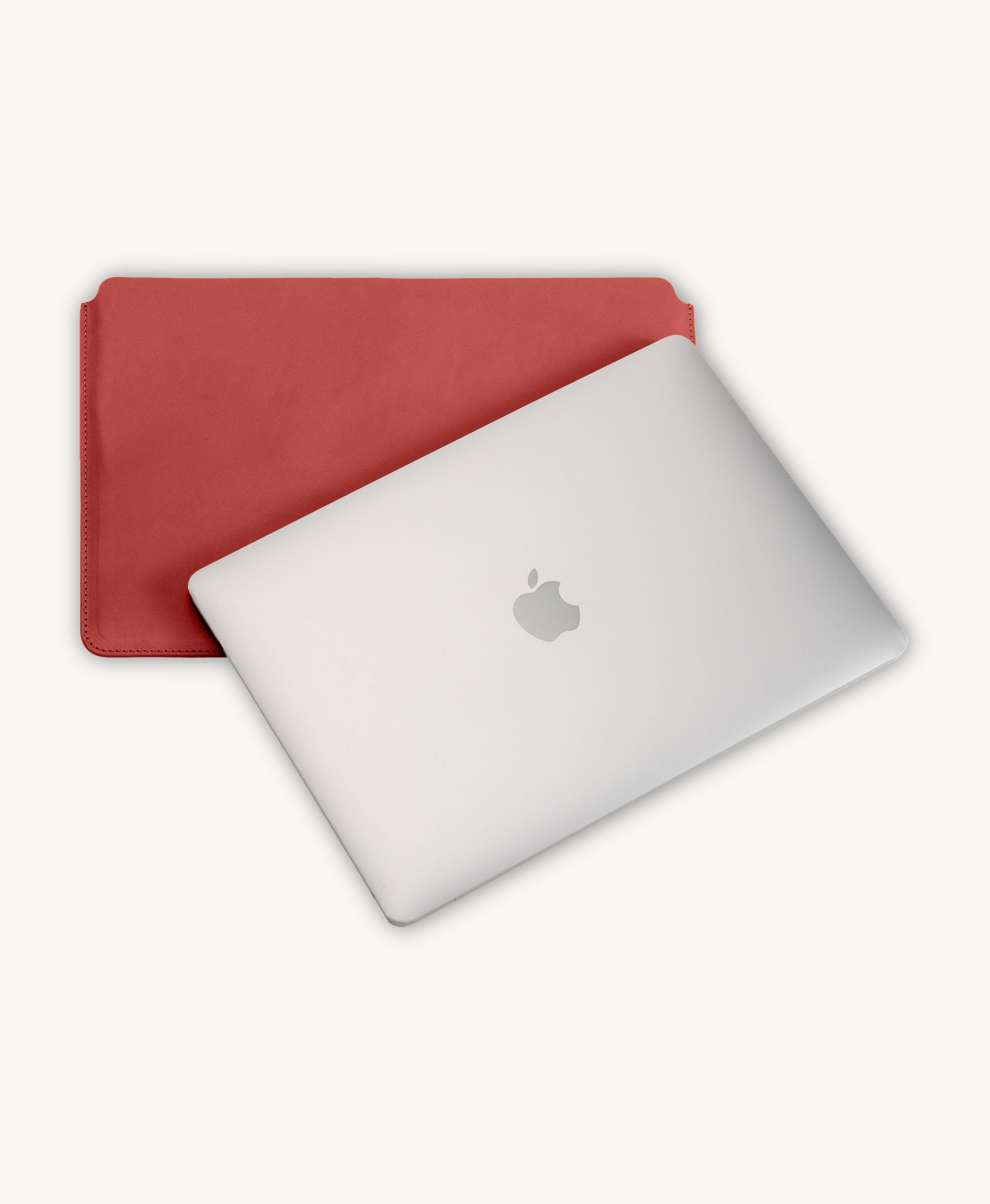 Red full grain saddle leather laptop sleeve, shown with a MacBook