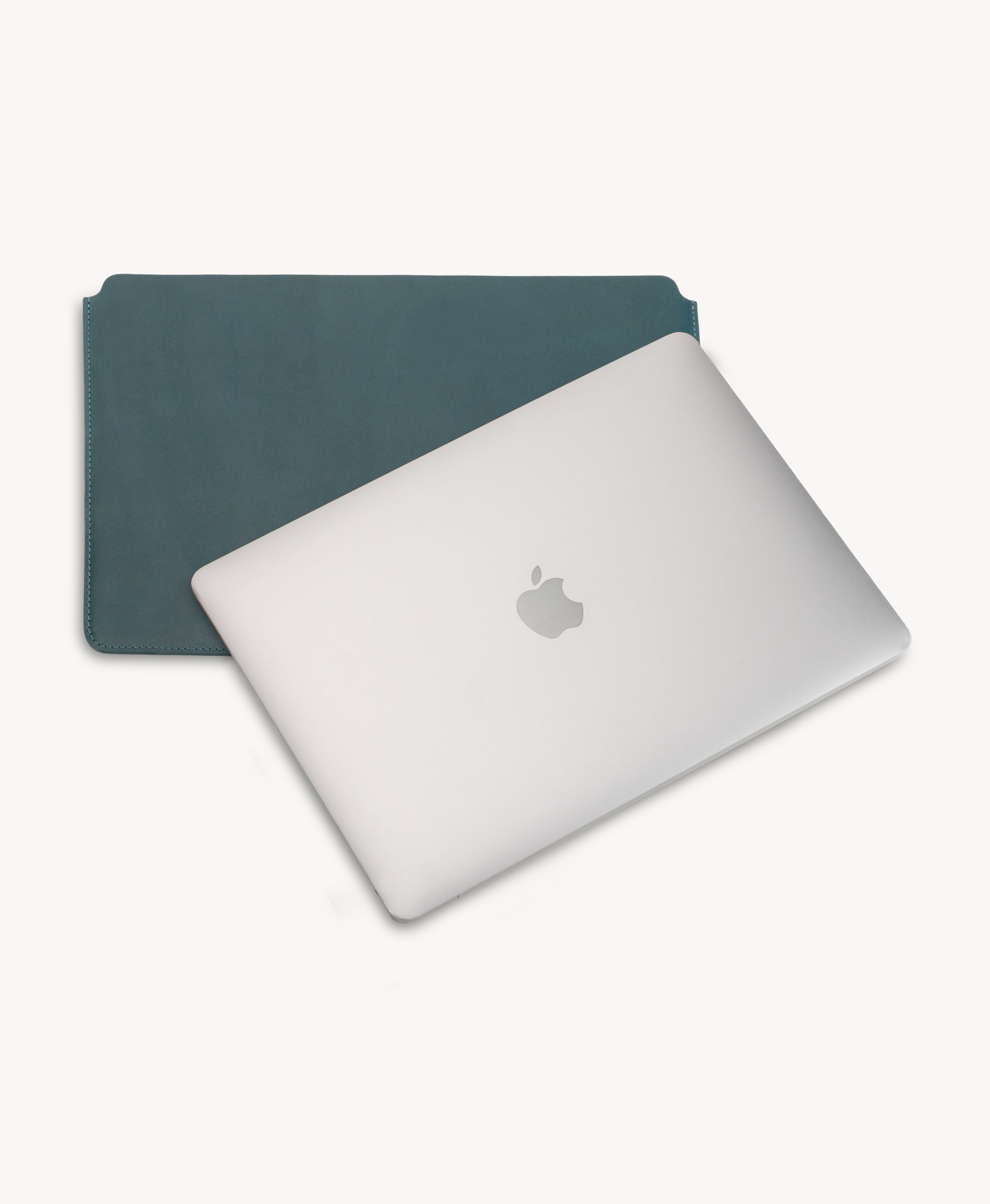 Blue full grain saddle leather laptop sleeve, shown with a MacBook