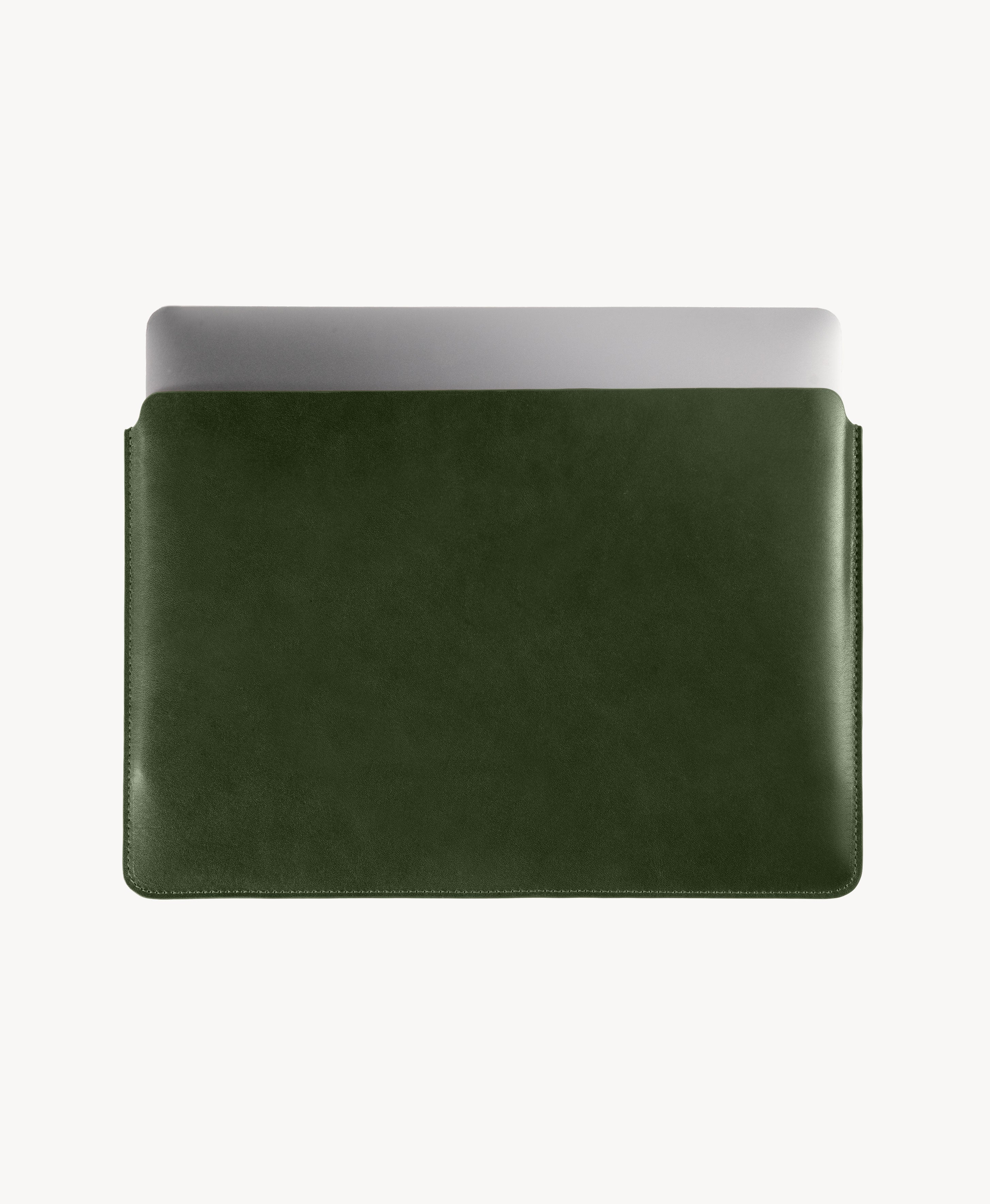 Forest Green full grain saddle leather laptop sleeve, MacBook partially inserted through the open top