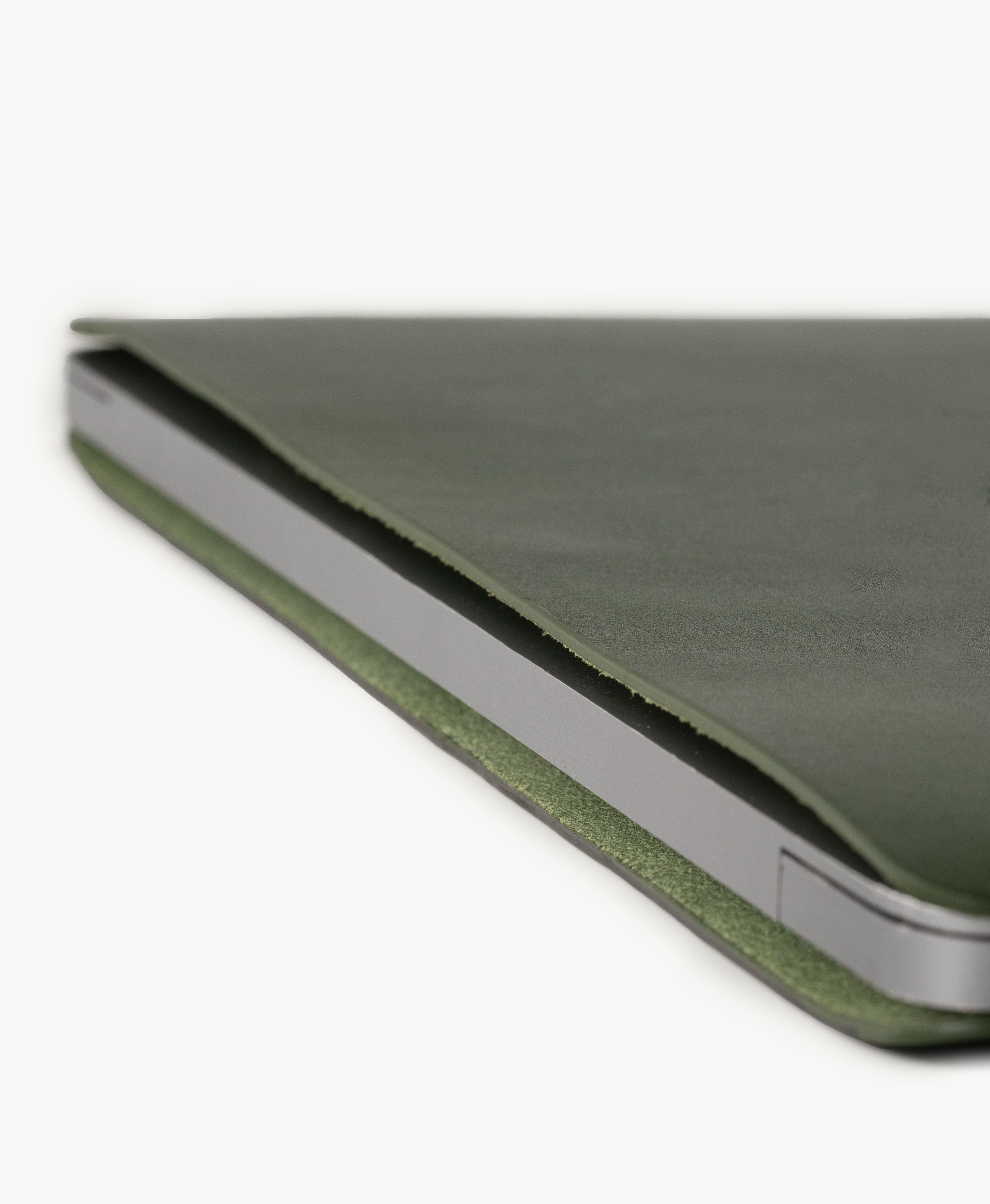 Forest Green full grain saddle leather laptop sleeve, slim side profile with a MacBook inserted